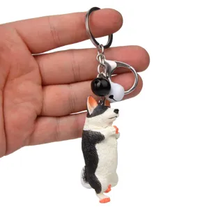 Niedlicher Yoga-Hund Schlüsselanhänger mit Glocken und Karabiner für Autoschlüssel und Taschen.