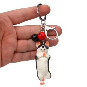 Nahaufnahme des lustigen Yoga-Hund-Schlüsselanhängers mit bunten Glocken für Taschen und Autos.