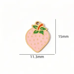 Close-up detail of a cute pink strawberry enamel charm pendant for DIY handmade jewelry crafts.