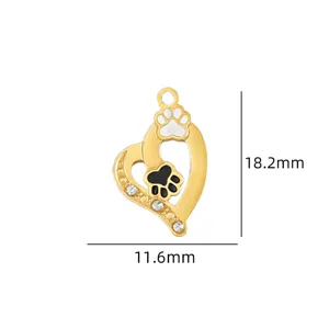 Close-up detail of the gold heart-shaped charm pendant with paw print and crystal rhinestones.