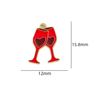Detail shot of a red wine glass enamel pendant charm with cute heart design, golden trim.