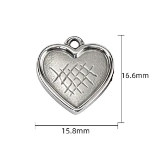 Detail shot of the vintage silver heart pendant charm with cross-hatch texture for DIY jewelry.