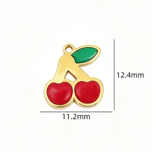 Detailed shot of gold-plated titanium steel red and green cherry pendant for DIY jewelry making.
