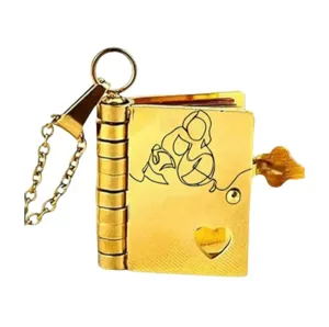 Detailed view of gold book pendant necklace, openable titanium steel locket with heart design.