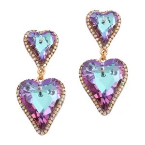Detailed view of heart-shaped earrings with purple and teal gradient crystals