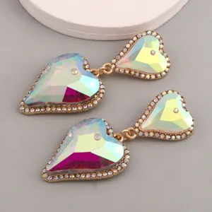 Exaggerated iridescent heart-shaped dangle earrings with sparkling rhinestone trim detailing