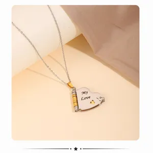 Detail shot of stainless steel heart letter locket necklace with delicate engraving.