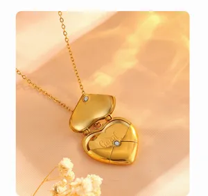 Gold heart locket necklace detail, openable envelope pendant, titanium steel jewelry close-up