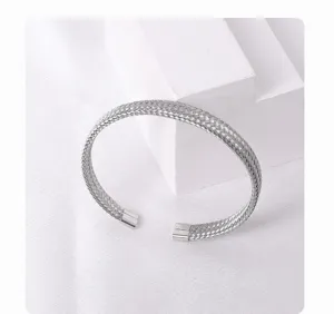 Exquisite titanium steel mesh weave cuff bracelet detail showcasing fine metallic texture.