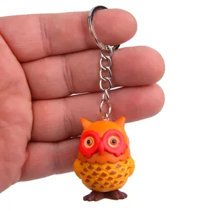 Cute owl keychain detail view, resin animal pendant with metal ring for bags and keys.