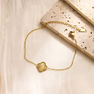 Exquisite gold-plated stainless steel clover bracelet detail, delicate faceted flower charm.