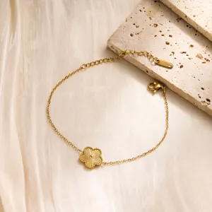 Gold stainless steel flower bracelet detail view, delicate clover charm jewelry close up display.