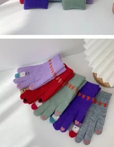 Close-up of cute winter knit touchscreen gloves with plush lining, colorful warm details.