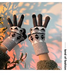 Detailed shot of winter knitted touch screen gloves featuring cozy geometric patterns and warm fit.