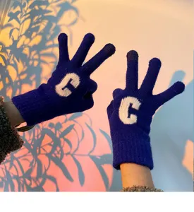 Blue knit winter gloves with white letter C pattern, warm touch screen cute apparel.