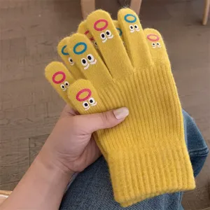 Cute winter warm knitted gloves for women with funny face embroidery, soft and cozy yellow mittens.