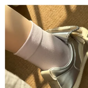Detail shot of solid color mid tube casual socks, soft fabric, breathable design.