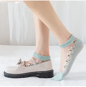 Sheer crystal floral socks detail shot, delicate lace trim and embroidered flower pattern.