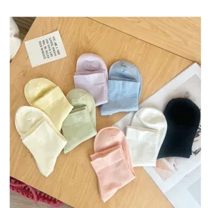 Close-up of colorful dopamine mid-tube socks flat lay on wooden table, soft and breathable.