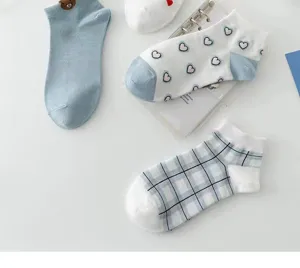 Close-up details of cute women's short socks featuring bear decor, heart prints, and plaid patterns.