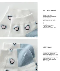 Detail view of cotton women's short boat socks featuring cute heart patterns and color blocks.