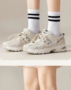 Unisex cotton mid-tube socks with classic black and white stripes, casual and stylish.