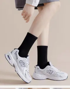 Black cotton mid-tube socks for men and women, casual sports style, comfortable daily wear.