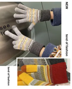 Winter warm knit gloves detail showing touch screen fingers, snowflake pattern and soft fleece lining.