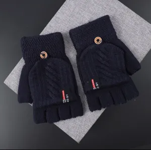 Close-up detail of winter women's half-finger knitted gloves with flip cover and button.
