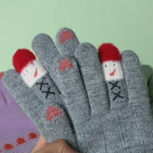 Cute winter knitted touchscreen gloves detail view with warm fleece lining and heart pattern.