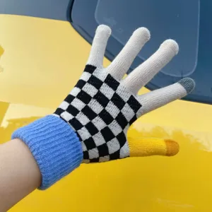 Close-up detail of knit touch screen gloves with black white checkerboard and yellow thumb.