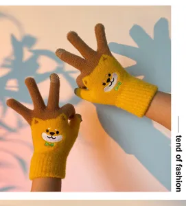 Detail view of cute cartoon knit winter gloves with warm plush lining and five fingers.