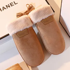 Close-up detail of winter warm plush-trimmed mittens, khaki fleece-lined cozy hanging gloves.