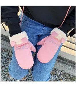 Close-up detail of cute pink cat ear plush mittens with hanging strap for winter warmth.