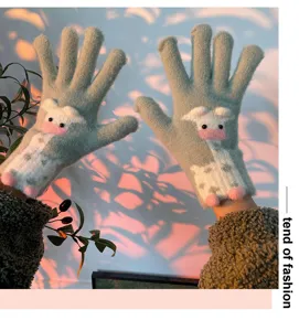 Detailed close-up shot of winter knitted touchscreen gloves with cute cartoon cow design.