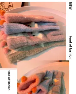 Close-up of cute knitted winter gloves featuring colorful plush design and funny details.