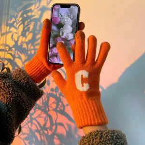 Orange knitted touchscreen gloves for women, winter warm cute solid color five-finger gloves.
