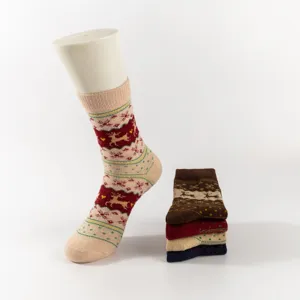 Detailed view of winter thick thermal Christmas socks with cute reindeer and snowflake pattern.