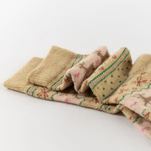 Close-up of women's warm Christmas mid-calf socks featuring vintage reindeer and metallic thread.