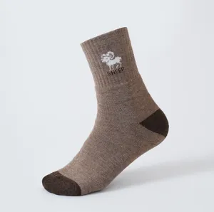 Detailed view of men's thermal winter loop socks in brown with cute sheep knit pattern.