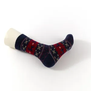 Close-up detail of Christmas knitted mid-tube socks with cute elk and snowflake pattern design.