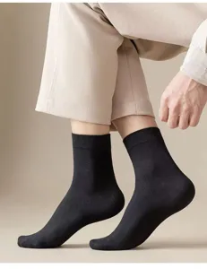 Men's black crew socks detail view, breathable solid color cotton socks for daily wear.