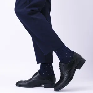 Mens business dress socks and brogue shoes detail shot showing sock pattern and leather footwear.