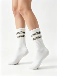 Non-slip grip yoga pilates socks for women, white crew socks with leopard stripes and rubber grips.