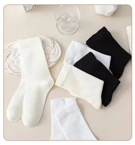 Close up of thin black and white crew socks, soft cotton material, casual daily wear.