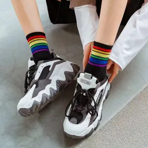 Trendy rainbow stripe mid-calf socks paired with chunky dad shoes for stylish daily wear.