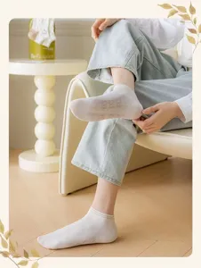 Detail view of women's breathable low-cut socks featuring cute bear patterns and stripes for daily wear.
