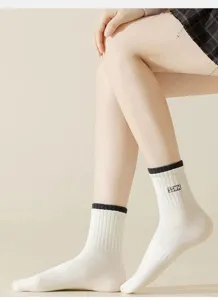 Comfortable white mid-tube women socks with black ribbed cuff and chic label detail.