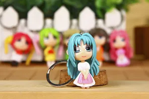 Cute anime girl keychain with blue hair and white dress, perfect bag accessory and gift.