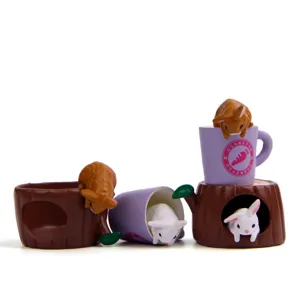 Detailed view of cute miniature rabbit figurines with tree stump and cup decor for DIY landscaping.